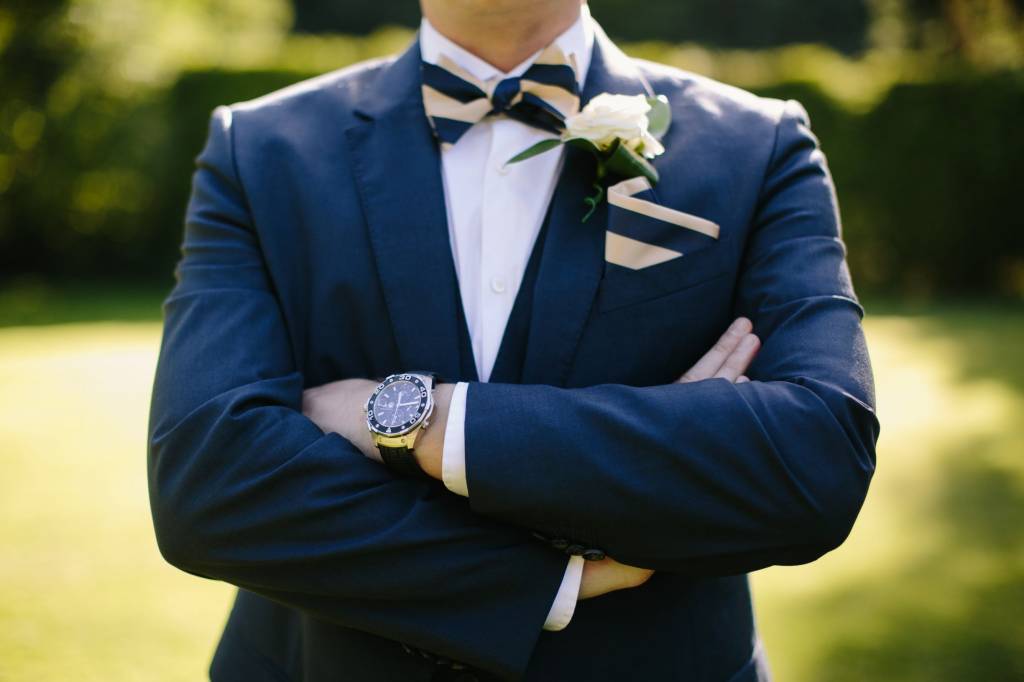 Image of a groom in a navy blue suit