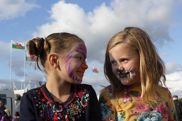 Usk Show 2017, two children enjoying a fun day after having their faces painted (above left) © Usk Show. A new Spring lamb (above right) © Crown copyright 2018 (Visit Wales).